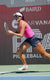 Image of Anna Bright in mid-stride. Tracking a pickleball with her paddle in hand.