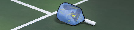 Banner image of a JOOLA Essentials Pickleball paddle on a pickleball court.