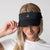 Female model showing off the JOOLA Essential Visor, black.