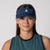 Headshot style image of a female model wearing a JOOLA Essential Visor, Navy.