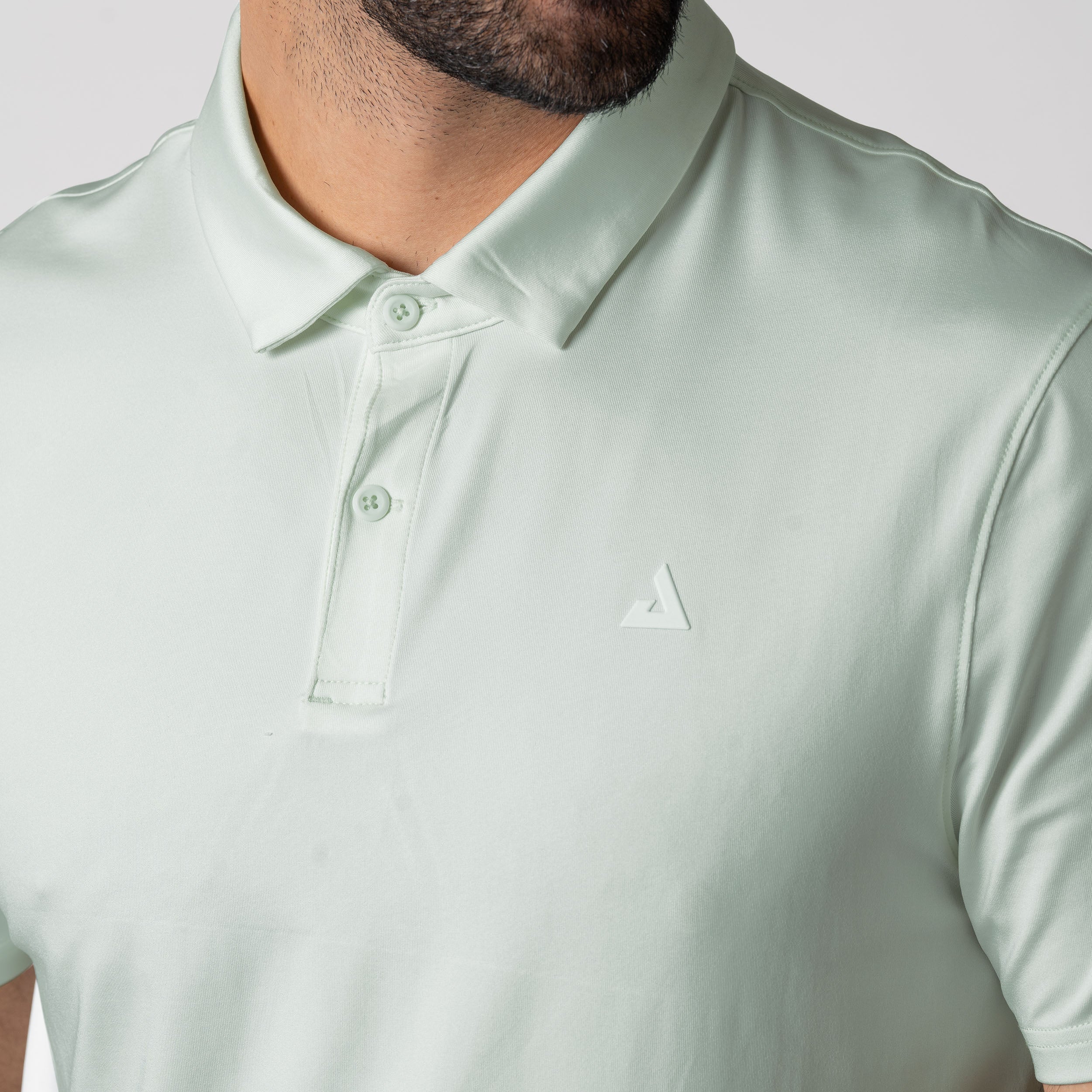 Close up image of the JOOLA Trinity Logo Branding on the Left Chest of the JOOLA Men's Club Polo, Hushed Mint.