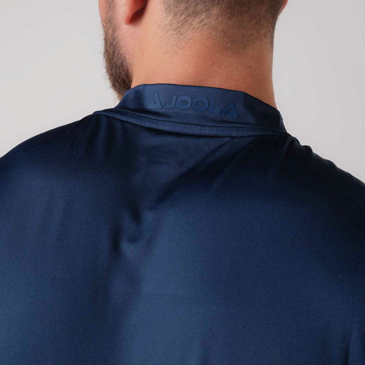 The modern self-fabric collar with no topstitch of the JOOLA Men's Court Polo, Navy.