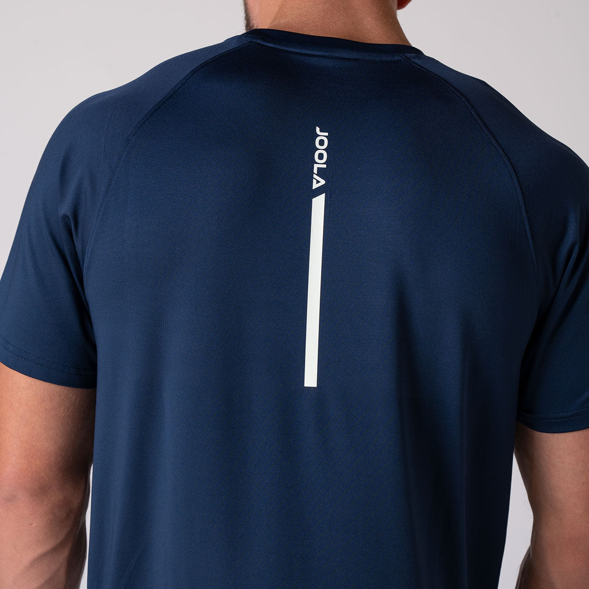 Image showing the back of a JOOLA model wearing a JOOLA Men's Court Short Sleeve shirt, navy.