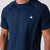 Close up image showing the JOOLA trinity logo on a JOOLA Men's Court Short Sleeve shirt, Navy.