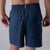 Close up image of the branded JOOLA Woven Pinch Tab on the back waistband on a pair of JOOLA Men's Woven Shorts, Navy.