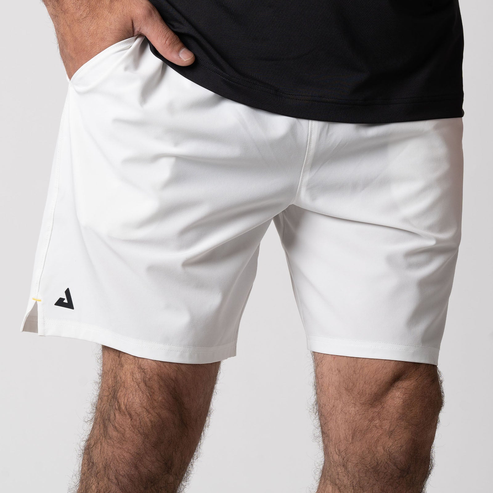 Male model wearing a pair of JOOLA Men's Woven Shorts, White.