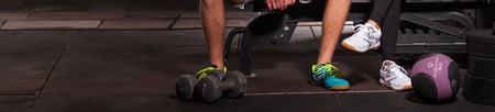 Horizontal banner image of two people, male and female wearing JOOLA shoes at the Gym.